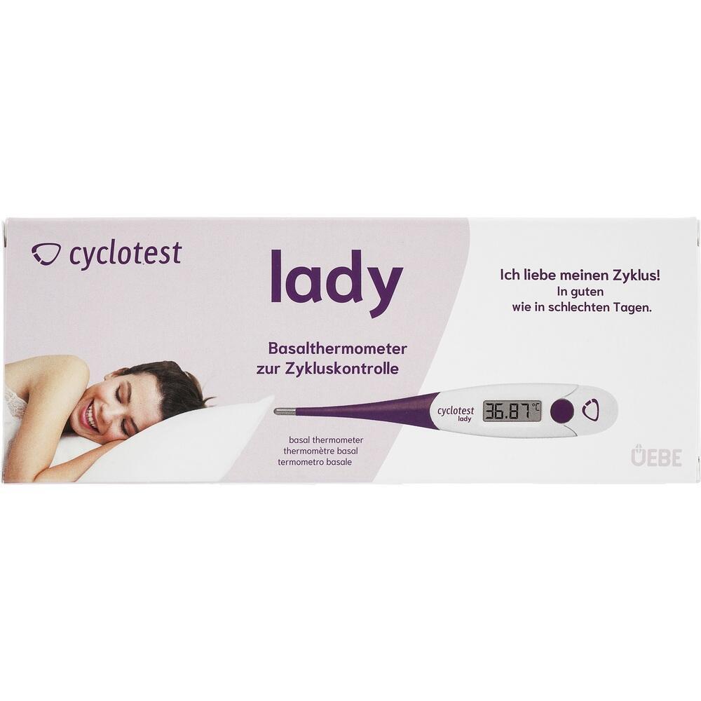 Eine Frau liegt l&auml;chelnd neben einem lila Basalthermometer zur Zykluskontrolle.
