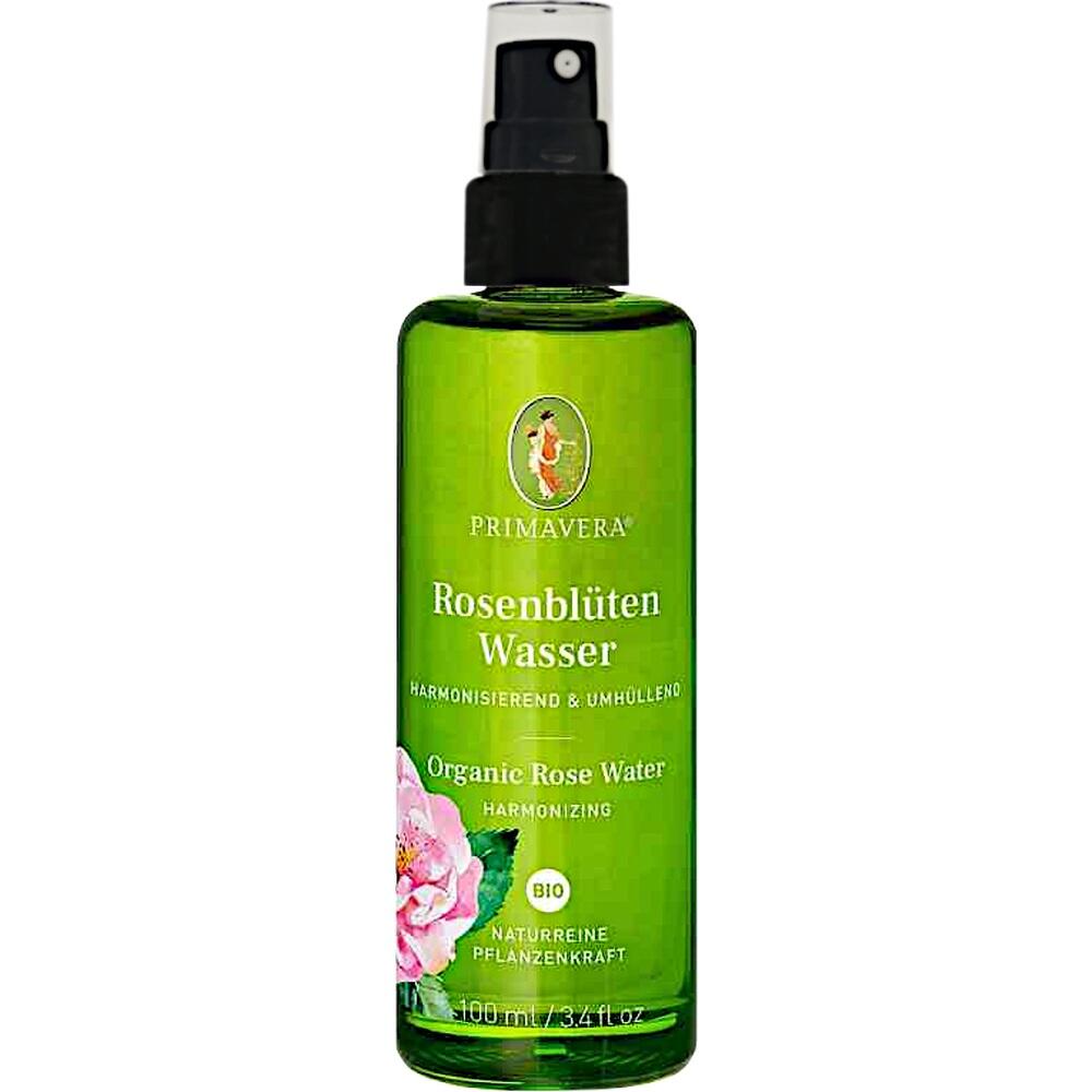Gr&uuml;ne Spr&uuml;hflasche mit Rosenbl&uuml;tenwasser, dekoriert mit rosa Bl&uuml;te.